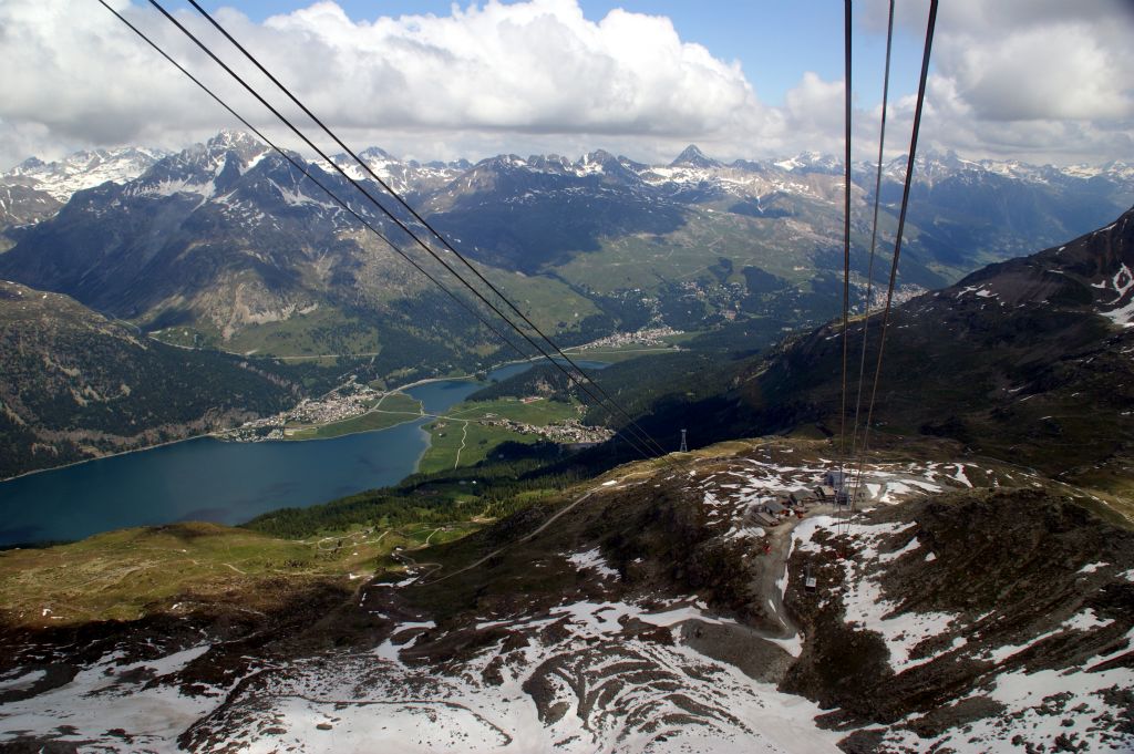 The view looking back towards Silvaplana to the left of the lake and Surlej to the right. St. Moritz is obscured by the mountain to the right. Corvatsch Mittelstation is just about visible at the end of the cables.